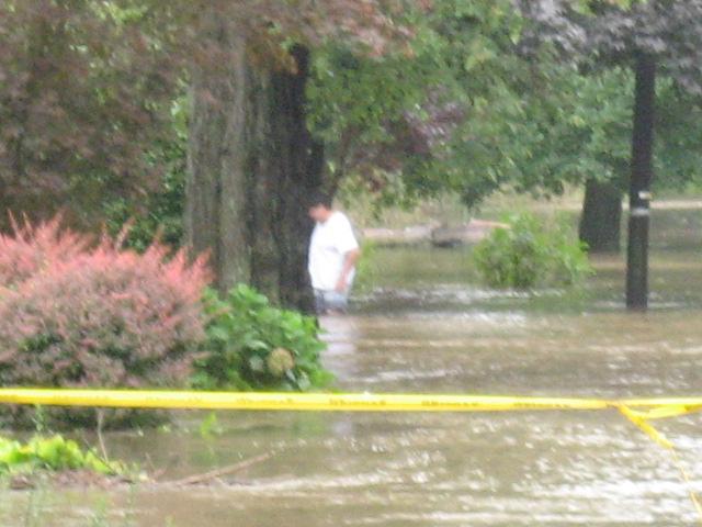Resident walking through flood waters on Milton Rd at Rye Beach Ave during Hurricane Irene